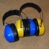 Peltor ear protection muffs. Blue pair is marked Peltor Bull's Eye Ultimate 10, yellow pair is