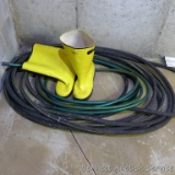 Two sections of garden hose. One is Apex and is larger and heavy duty. Lot also includes Talon Trax