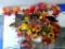 Several stems of faux harvest themed pumpkins and flowers. Some flowers, pumpkins, and a crow are