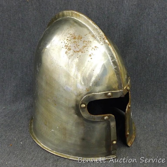 Medieval style helmet is about 10-1/2" x 9" x 10-1/2" high. Small specklings of rust make it look
