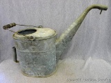 Really cute galvanized watering can with original wooden handle stands about 1-1/2' tall