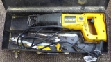 DeWalt DW304 reciprocating saw with used blades and metal storage case, runs.