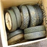 Fourteen used lawn mower wheels. Largest is 7-1/2