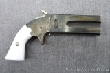 Over-under muzzle loading black powder percussion cap pistol has a unique rotating barrel assembly.