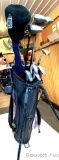 Vintage golf clubs and bag with stand, includes 3 metal woods, one Taylor Made # 3 metal wood, one