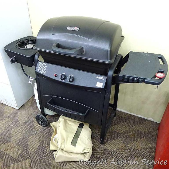 No shipping. Nice Char-Broil gas grill with cover, grilling spatulas, and a partial tank of gas.