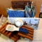 Wicker basket filled with pot holders, trivets, spoon rest and timer; basket measures 9