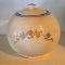Vintage round or ball canister has uniform crazing and pretty flowers. Measures approx. 8