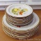Vintage stoneware plates with a daisy pattern includes seven dinner plates and nine salad or dessert