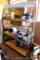 Sturdy shelf unit is set up for starting plants with three light fixtures attached at each shelf.