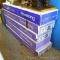 Five unopened boxes of Armstrong Country Classic Plank ceiling tiles have a wood grain look. Tiles