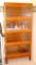 Vintage storage cabinet is framed in wood with glass doors that lift up and push in for access to