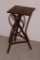 Interesting stand for plant display or side table is made from wooden branches and smaller stems