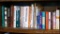 Shelf of books with a variety of subjects including health and healing, workshop books, gardening