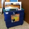 Folding crate filled with matted photos and a few wooden frames; crate measures 15