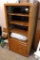 Storage cabinet with glass door has adjustable shelves and bottom storage. Unit measures approx. 4'