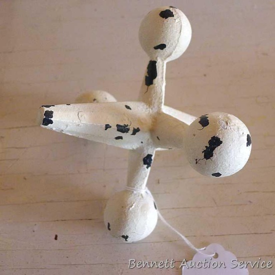 Cast iron replica of a toy jack could be used as a paper weight. Center is 6" long.