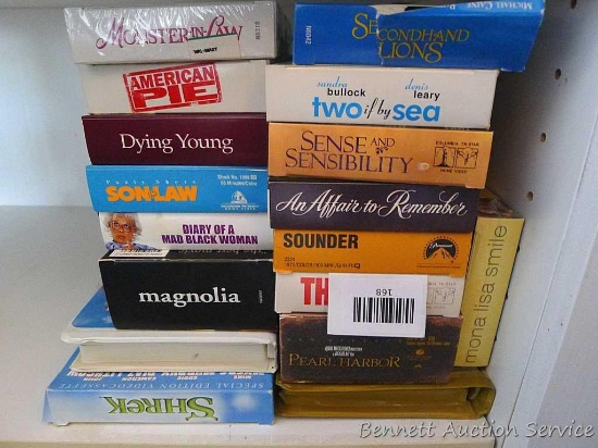 Stack of VHS movies including Pearl Harbor; American Pie; The Net; Magnolia; Dying Young; Shrek;
