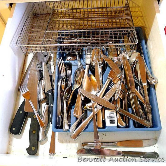 Two utensil organizers with assortment of silverware and sharp knives.