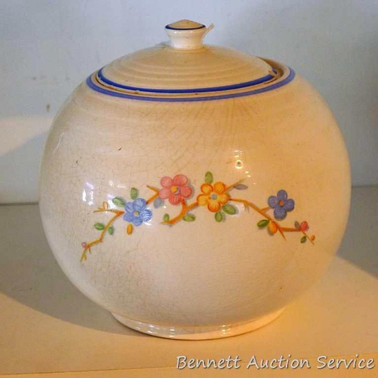 Vintage round or ball canister has uniform crazing and pretty flowers. Measures approx. 8" across x