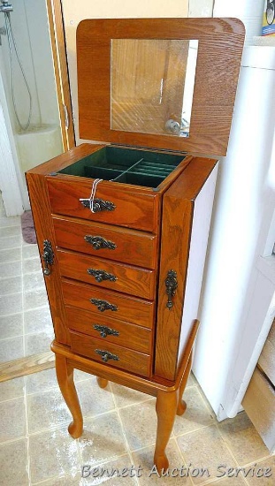Beautiful wooden jewelry storage cabinet. Main section has 5 pull out drawers with ring storage on