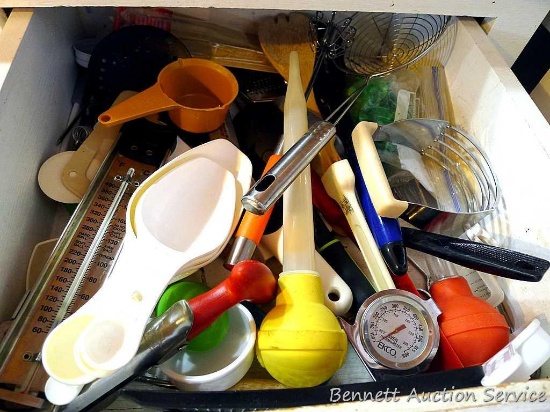 Kitchen utensils including a neat apple corer, pastry blender, baster, thermometers, measure cups,