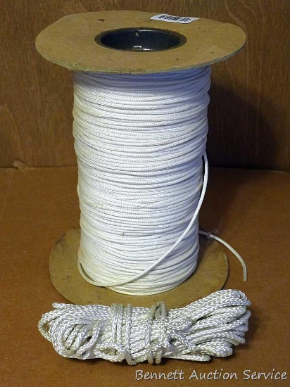 10" tall spool of nylon twine, plus a smaller coil of rope.