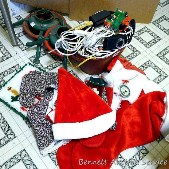 Two Christmas tree stands, larger is 24" across feet; extension cords; timer; Christmas stockings,
