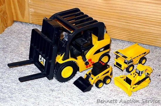 Caterpillar toys. Largest is a fork lift 6" x 15" x 8".