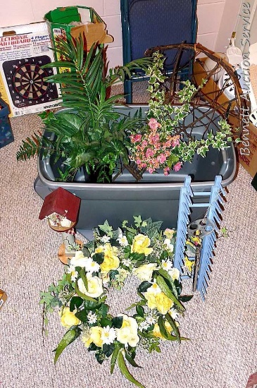 Sterilite 30 gallon tote with lid filled with artificial greenery; pretty bird wind chime;