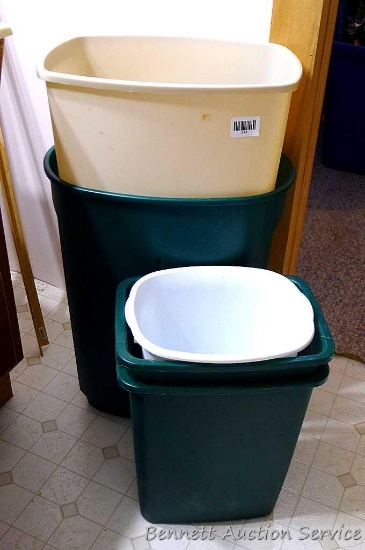 Five plastic garbage cans. Largest is 22" tall.