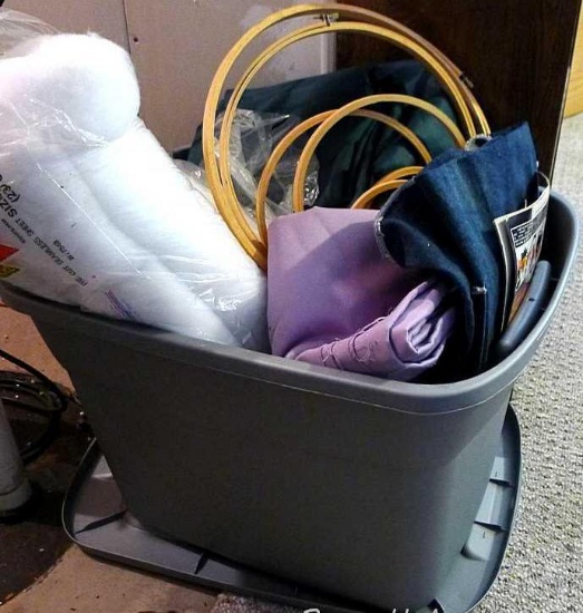 Sterilite 18 gallon tote with lid contains batting; table cloths; wooden embroidery hoops up to 15";