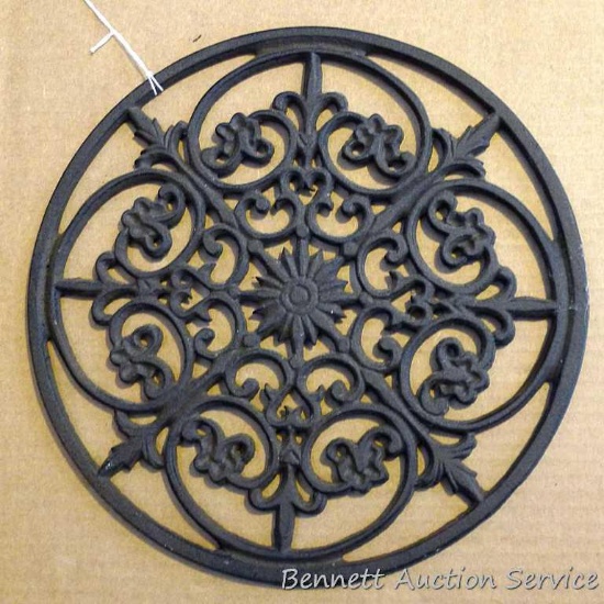 Interesting cast metal trivet or wall hanging; measures 12" diameter.