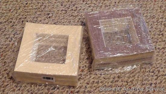 Two wrapped stacks of 8"x8" photo mats, each stack is approx. 3" thick.