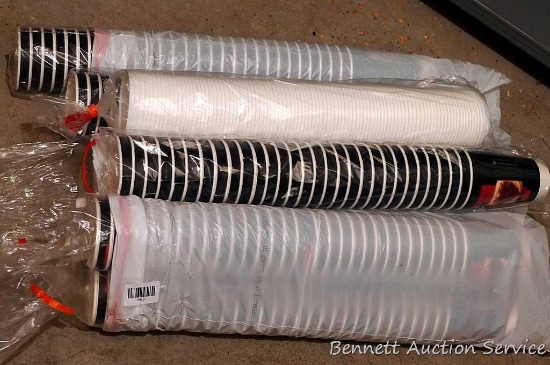 Lots of Nescafe paper coffee cups and lids
