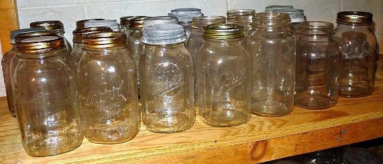 Shelf of quart narrow mouth canning jars with brands Ball, Kerr, Atlas and some with no brand names.