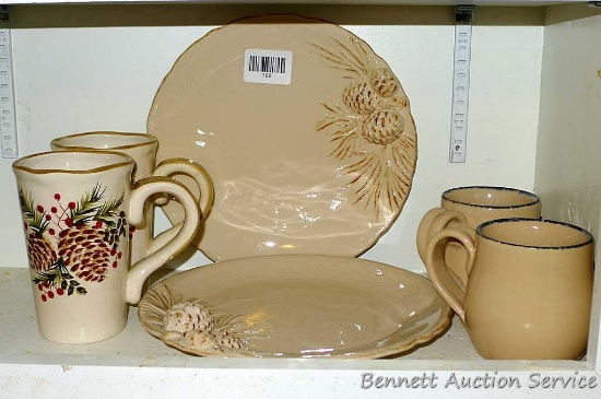 Two 10" pinecone pottery plates, plus two tall complimentary cups and two other mugs. All in good