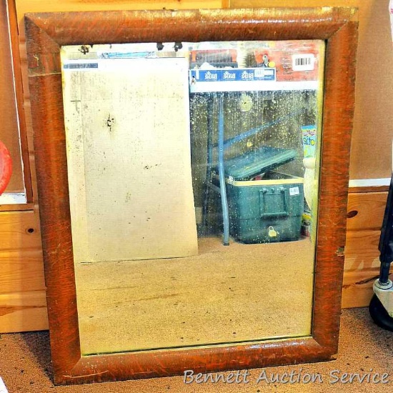 Antique wood framed mirror has some silvering missing, measures approx. 27" x 33". Wood frame is dry