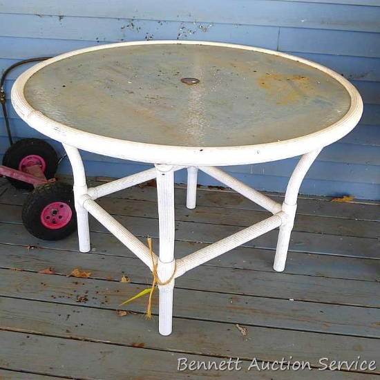 Glass topped patio table is about 43" wide and 28" high.
