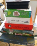 Stack of games for family fun includes Yahtzee Deluxe, Last Word, Scattergories, Scrabble Deluxe,
