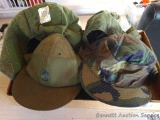 Two military cold weather cap helmet liners size 7; camo cap size 6-3/4; another hat size 6-7/8.