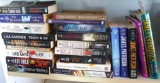 Stack of books from authors Harlan Coben, Lee Child, Nancy Bush, Lisa Gardner, James Patterson,