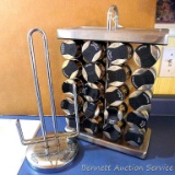 Freestanding spice rack has glass canisters neatly labeled. Unit measures 16