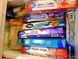 Variety of new and partial boxes of plastic wrap, parchment paper, ziploc bags, aluminum foil, waxed