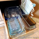 Glass baking pans including 9x13, 8x8, loaf pans, more. Some with lids.