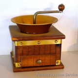 Retro coffee grinder has copper toned accents and measures 6-1/2