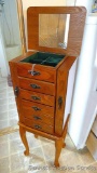 Beautiful wooden jewelry storage cabinet. Main section has 5 pull out drawers with ring storage on