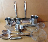 Nice assortment of stainless steel kitchen utensils including ladles, scoops, pitchers, spatulas,