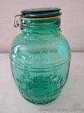 Cracker Barrel Style 4 quart green glass jar with snap on lid and rubber seal. Jar measures 11