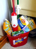 Mop bucket filled with O Cedar Promist spray mop, sponge mop, swiffer duster and refills and more.